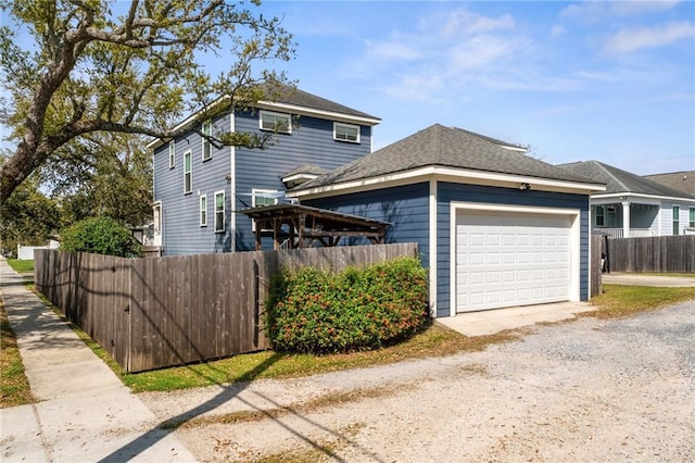 view of front of home featuring fence, a garage, and driveway