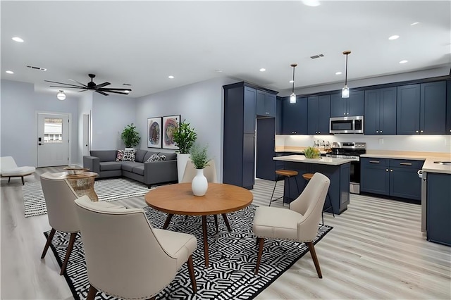 living room featuring light wood finished floors, visible vents, recessed lighting, and ceiling fan