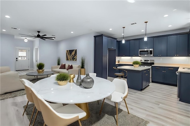 dining space with recessed lighting, a ceiling fan, visible vents, and light wood-type flooring