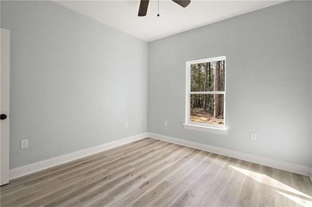 empty room featuring baseboards, light wood-style floors, and ceiling fan