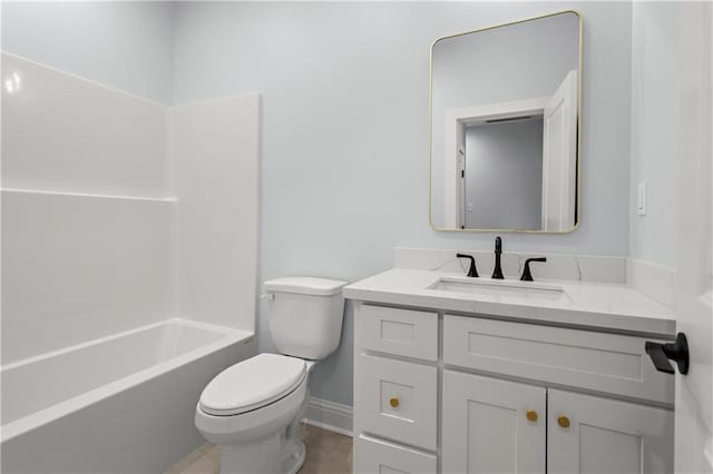 bathroom featuring vanity, bathing tub / shower combination, toilet, and baseboards