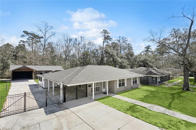 ranch-style house featuring fence, concrete driveway, a front yard, stucco siding, and a gate