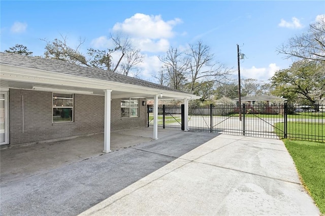 view of patio / terrace with a gate, a carport, and fence