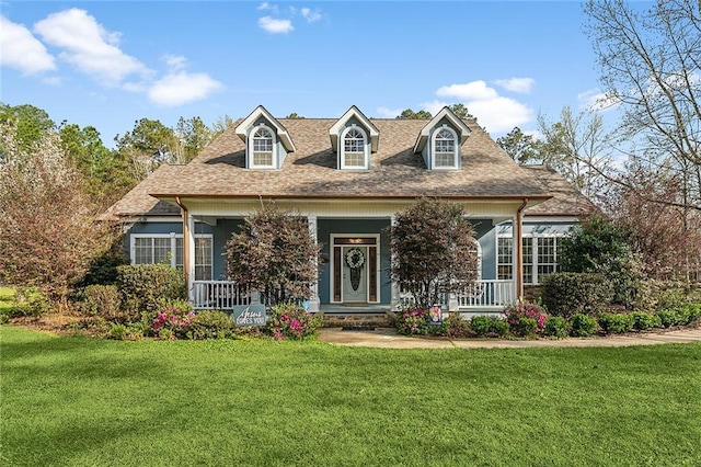 cape cod house featuring a porch, a front yard, and roof with shingles