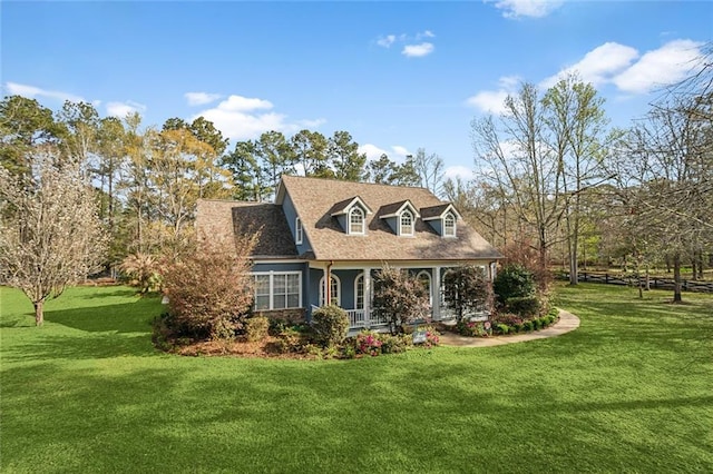 view of front of home with covered porch and a front yard