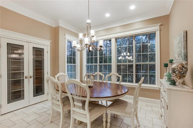 dining room with baseboards, an inviting chandelier, stone tile flooring, and crown molding