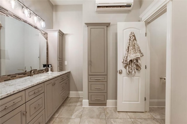 bathroom featuring a wall mounted air conditioner, baseboards, and vanity