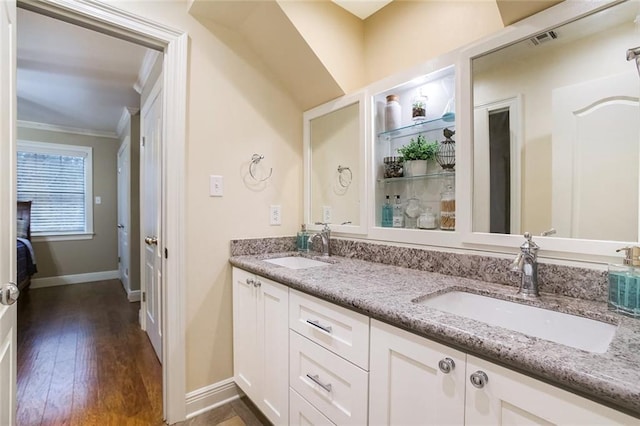 full bath with double vanity, ornamental molding, visible vents, and a sink