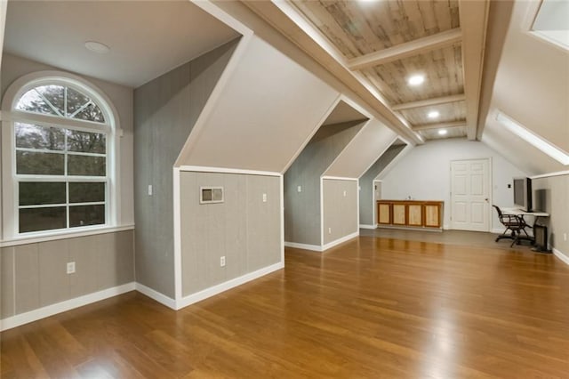 additional living space with wood finished floors, visible vents, baseboards, vaulted ceiling with beams, and recessed lighting