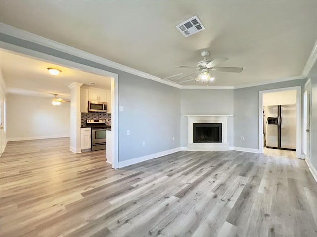 unfurnished living room featuring crown molding, light wood-type flooring, visible vents, and ceiling fan