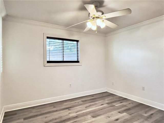 unfurnished room featuring crown molding, wood finished floors, and baseboards