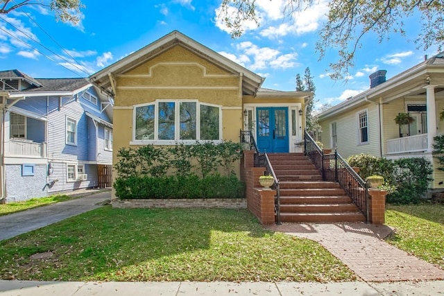 view of front of property with a front lawn and stucco siding