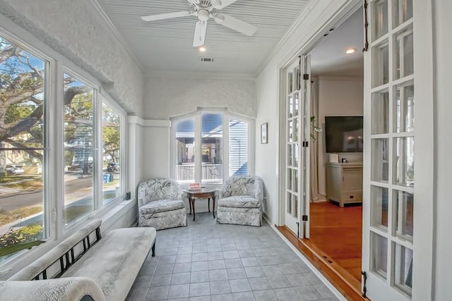 sunroom / solarium featuring visible vents, a healthy amount of sunlight, and ceiling fan