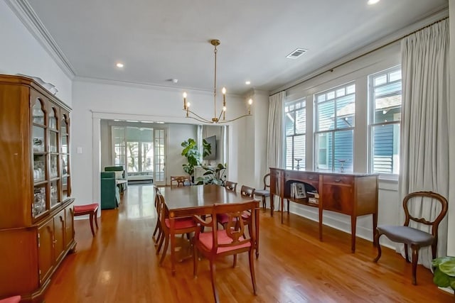 dining room with wood finished floors, visible vents, and a wealth of natural light