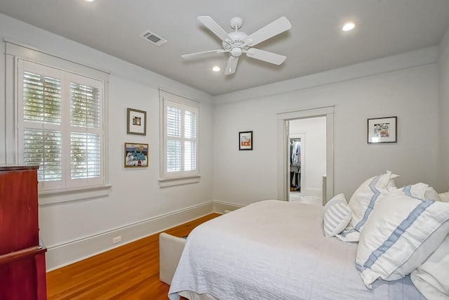 bedroom featuring visible vents, wood finished floors, recessed lighting, baseboards, and ceiling fan