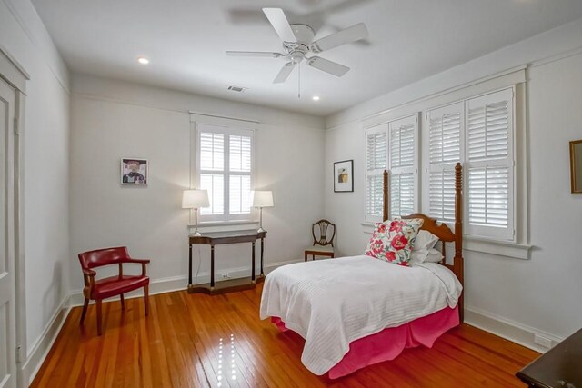 bedroom with visible vents, recessed lighting, baseboards, and wood finished floors