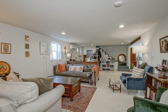 carpeted living room with recessed lighting, stairs, and a wall unit AC