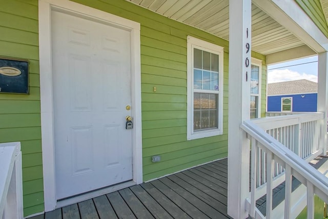 view of exterior entry with a porch