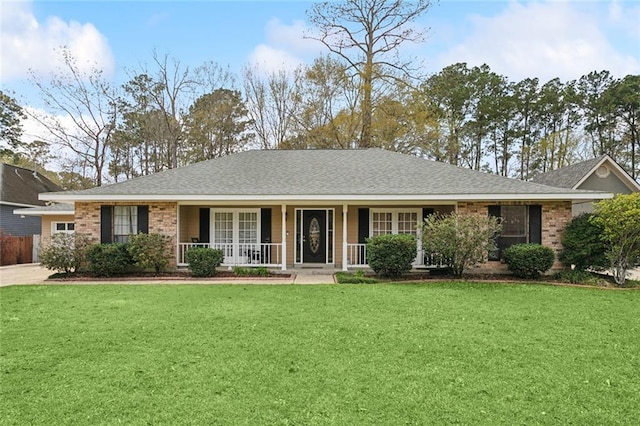 single story home featuring brick siding, a porch, a front yard, and roof with shingles