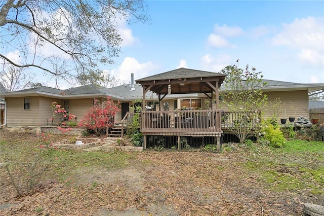 rear view of house featuring a gazebo and a deck