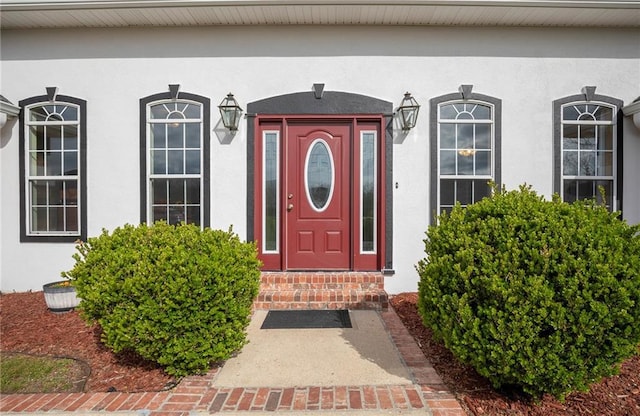 property entrance featuring stucco siding