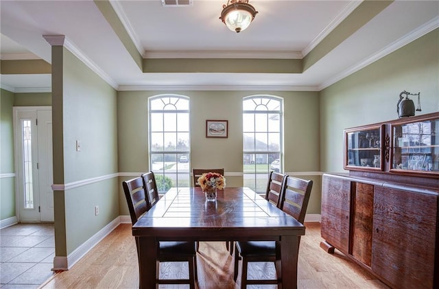 dining room featuring visible vents, crown molding, and a tray ceiling