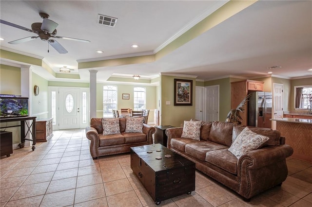 living area with light tile patterned flooring, visible vents, recessed lighting, and crown molding