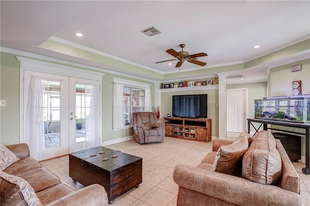 living area featuring light tile patterned flooring, visible vents, french doors, and ornamental molding