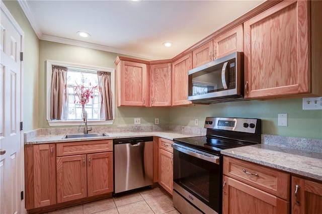 kitchen featuring crown molding, light stone countertops, light tile patterned floors, stainless steel appliances, and a sink