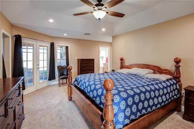 bedroom with ceiling fan, a tray ceiling, recessed lighting, light colored carpet, and access to exterior