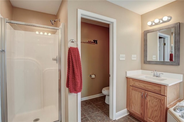 full bathroom with toilet, a stall shower, tile patterned flooring, baseboards, and vanity