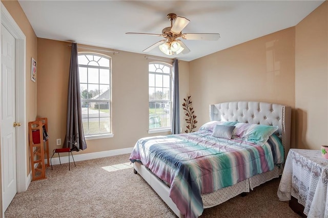 carpeted bedroom with a ceiling fan and baseboards