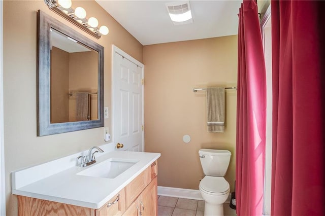 bathroom featuring tile patterned floors, baseboards, toilet, and vanity