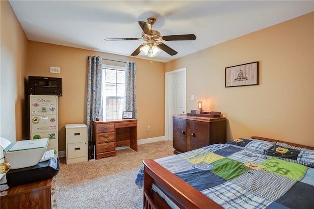 carpeted bedroom featuring a ceiling fan and baseboards