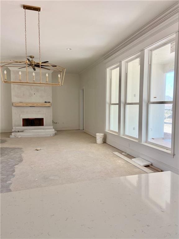 unfurnished living room featuring a fireplace with raised hearth and ornamental molding