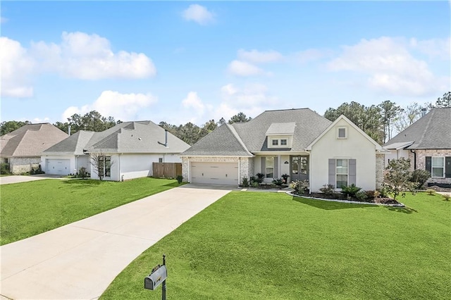 view of front of home featuring driveway, an attached garage, and a front lawn