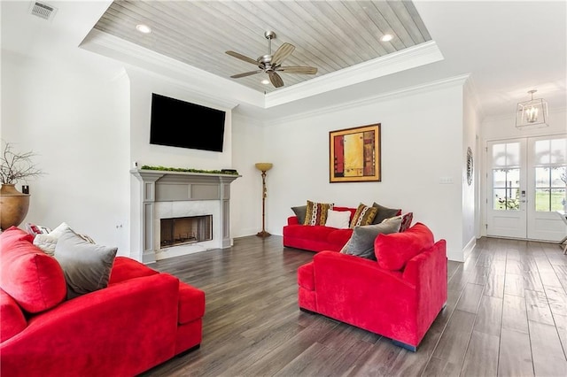 living area featuring visible vents, wooden ceiling, a raised ceiling, and wood finished floors