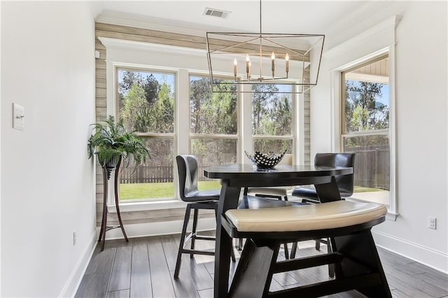 dining room with visible vents, a healthy amount of sunlight, a chandelier, and dark wood-style flooring