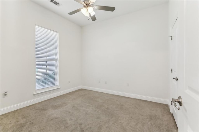 spare room featuring baseboards, visible vents, carpet floors, and ceiling fan