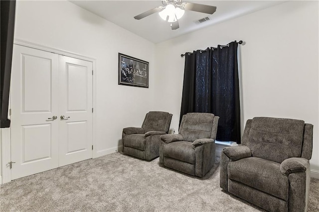 sitting room with baseboards, carpet, visible vents, and ceiling fan