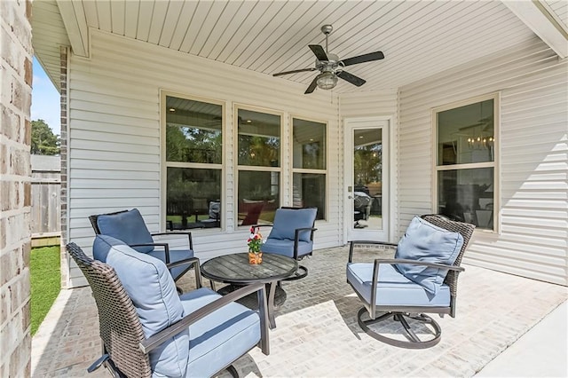 view of patio with outdoor lounge area, a ceiling fan, and fence