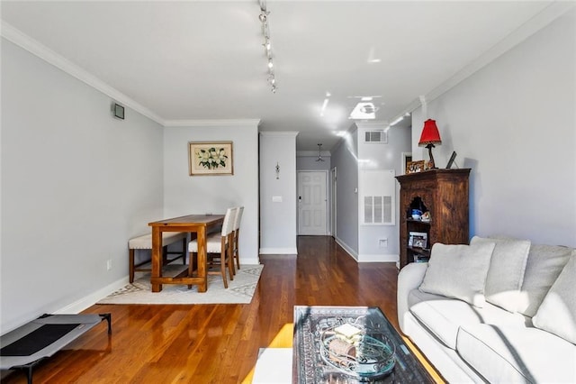 living room featuring baseboards, wood finished floors, visible vents, and ornamental molding