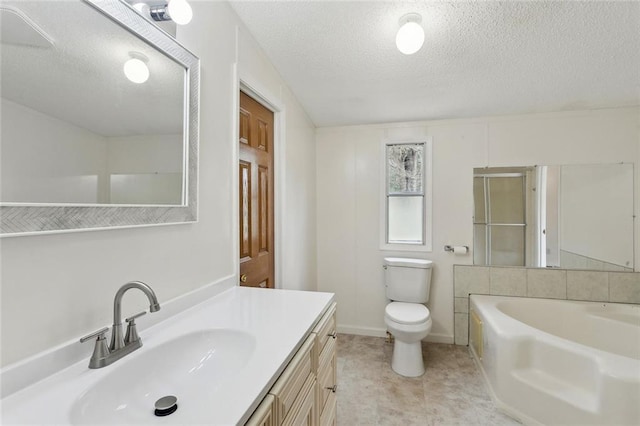 bathroom featuring vanity, baseboards, a textured ceiling, toilet, and a bathtub