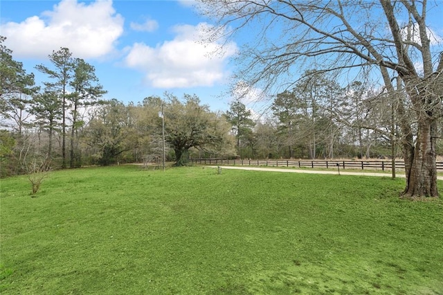 view of yard featuring a rural view and fence