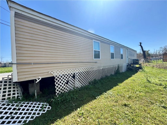 view of side of home featuring a yard