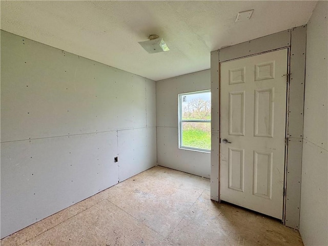 spare room featuring a textured ceiling