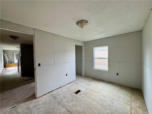 empty room with a textured ceiling