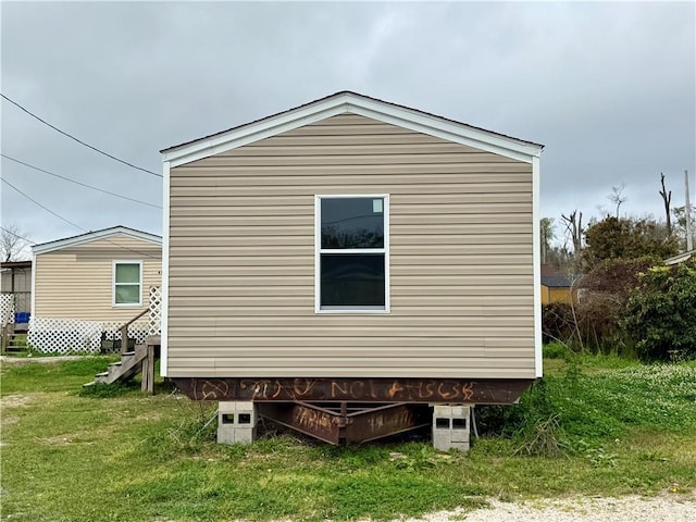 view of property exterior featuring a lawn