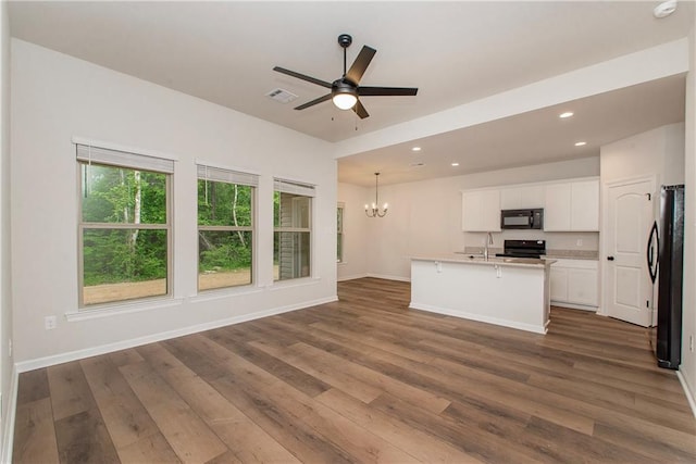 20069 Narretto Rd, Loranger, LA 70446 - unfurnished living room featuring a sink, ceiling fan with notable chandelier, recessed lighting, dark wood-type flooring, and visible vents