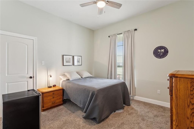 bedroom with ceiling fan, baseboards, and carpet floors